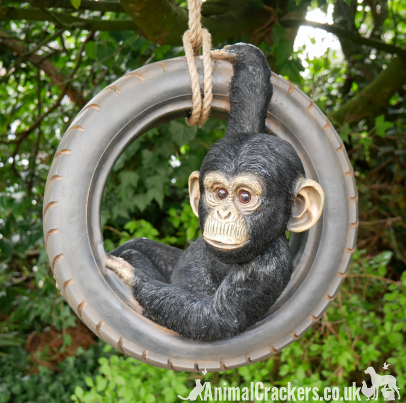 Chimpanzee swinging on old tyre rope swing, novelty tree garden ornament decoration, monkey or ape lover gift